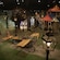 An antique, wooden airplane model is surrounded by models of houses with grass and trees